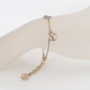 Louis Vuitton. Two-tone metal bracelet with logo pendant