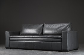 Three-person sofa upholstered in leather