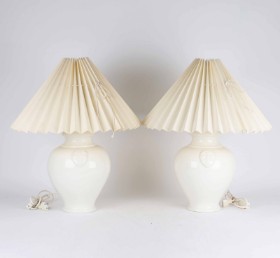 A pair of earthenware table lamps, cream colored with folding shades (2)