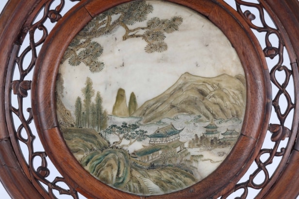 Chinese two-sided porcelain painting mounted in a carved wooden frame on a foot