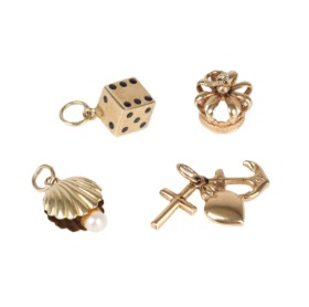 Four charms/pendants respectively of 14k and 18k gold. (4)