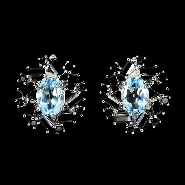A pair of rhodium-plated sterling silver earrings with faceted topazes and black spinels. (2)