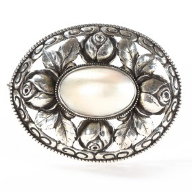 Silver oval brooch w/ mother of pearl.