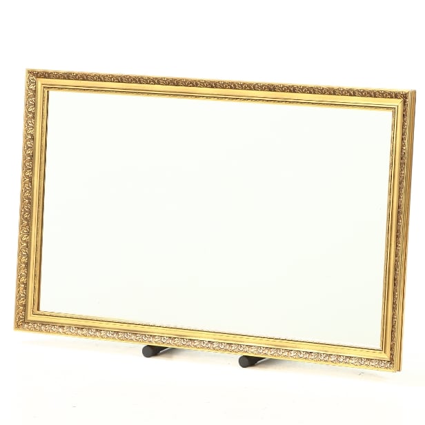 Mirror in a frame of gold-bronzed wood and gesso. 70 x 113 cm.
