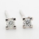 Pair of solitaire diamond earrings, 14 kt. white gold, approx. 0.10 ct