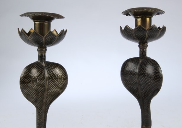 A pair of vintage cobra candlesticks in brass and enamel work (2)