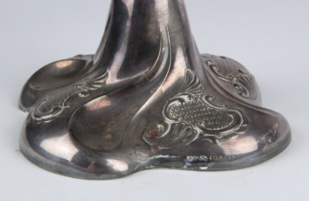 A pair of Empire style candlesticks, a silver candlestick, a glass candlestick (4)