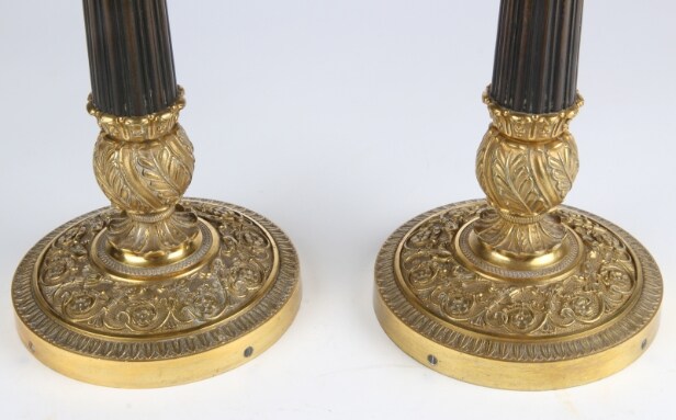 A pair of Empire style candlesticks, a silver candlestick, a glass candlestick (4)