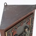 Small corner cabinet with carved figures on the door