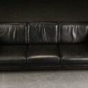 Tre-personers sofa af sort læder.
