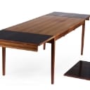 Danish furniture manufacturer. Rosewood dining table with 4 chairs (8)