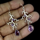Earrings in rhodium-plated Sterling silver adorned with numerous amethysts.