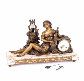 Mantel clock with marble plinth top with a woman playing the lute