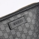 Gucci: A zipped wallet of black microguccissima embossed leather. Model 449423.