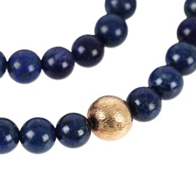 Ole Lynggaard: A ball clasp of 14k gold and a lapis lazuli necklace. (2)