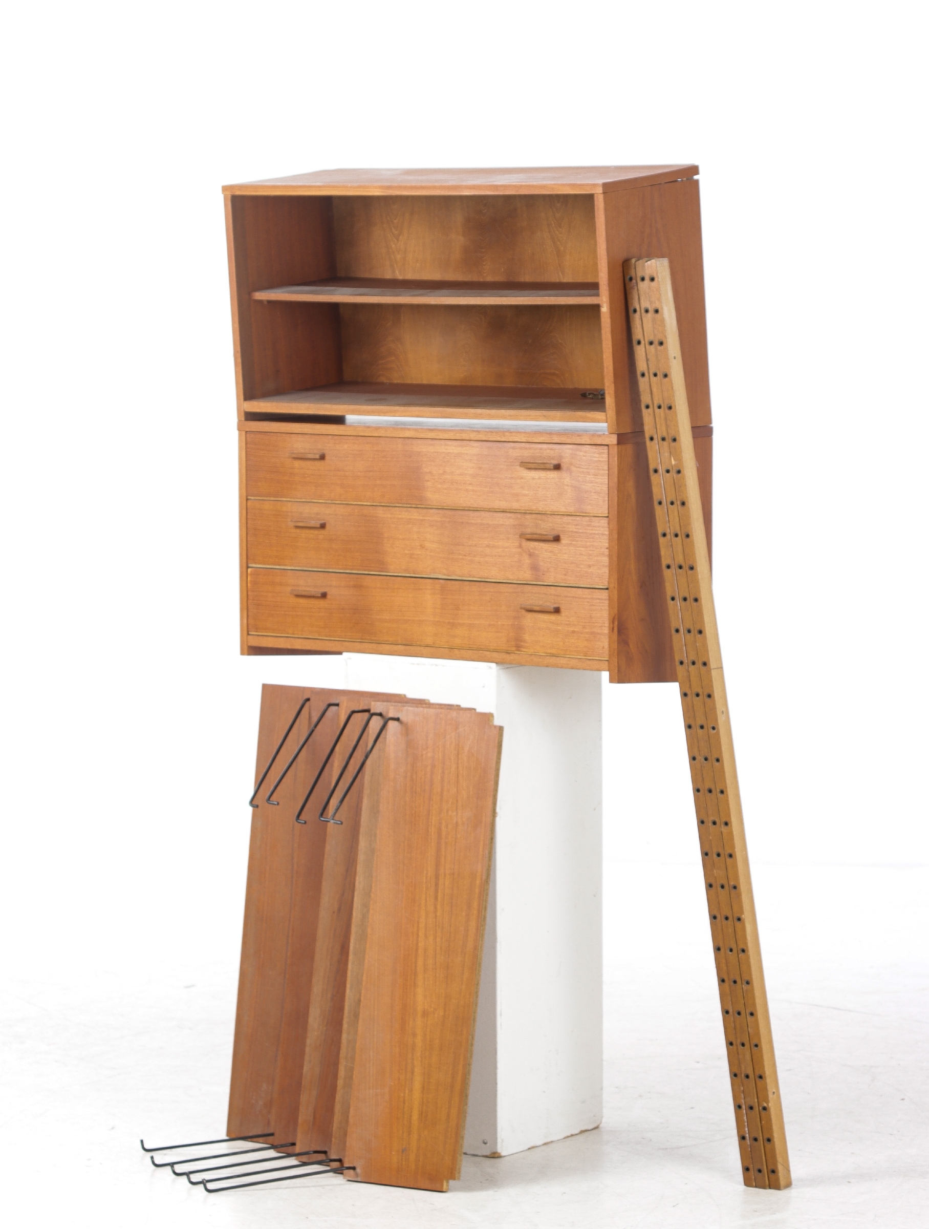 Wall-mounted shelving system made of teak wood. (10)