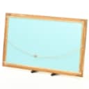 Mirror in a frame of gold-bronzed wood and gesso. 70 x 113 cm.