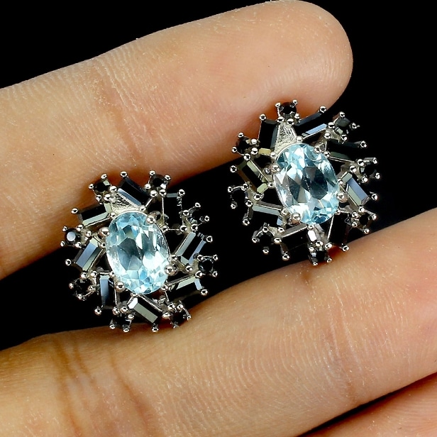 A pair of rhodium-plated sterling silver earrings with faceted topazes and black spinels. (2)