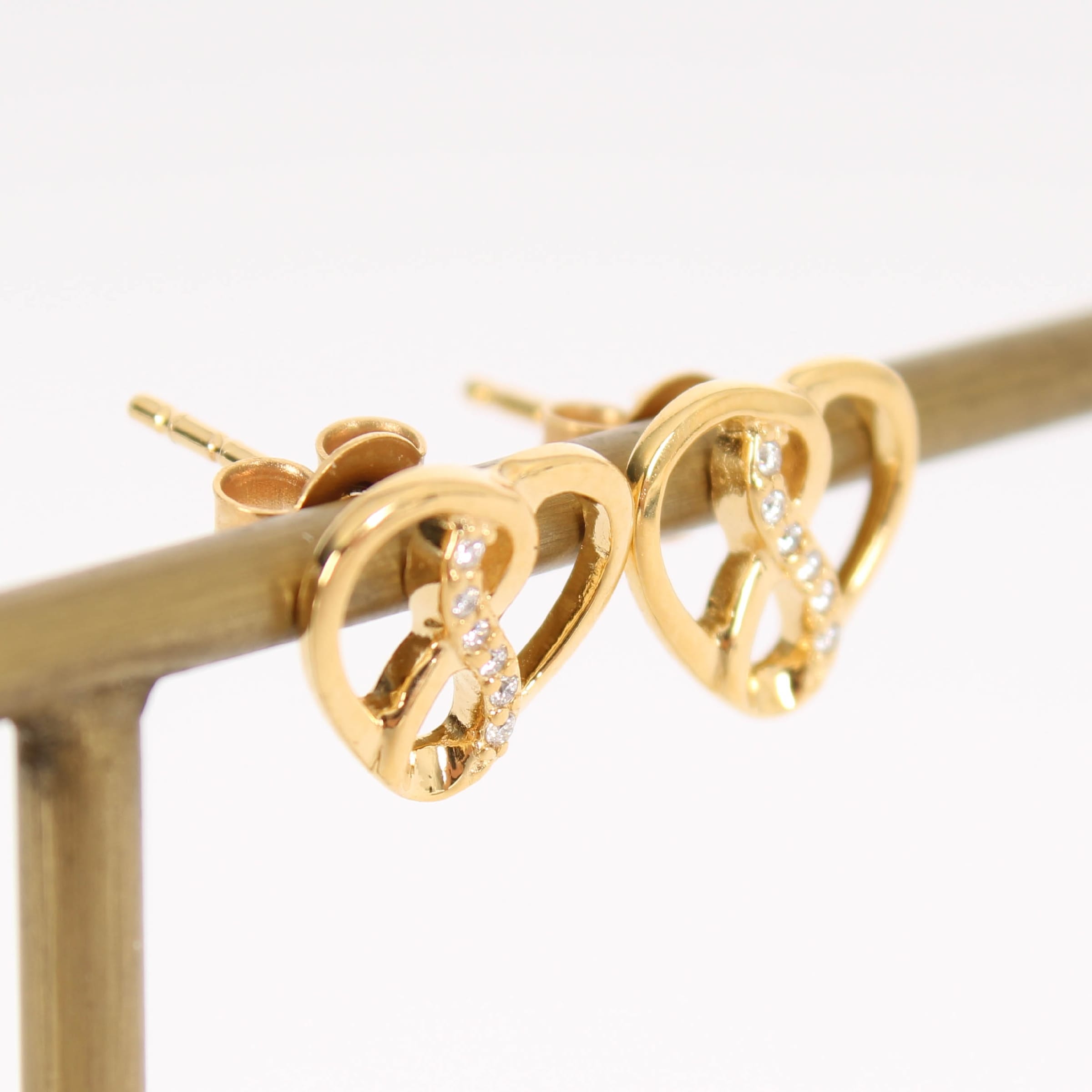 Pair of 14 kt. gold earrings with diamonds totaling 0.040 ct.