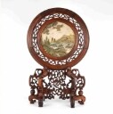 Chinese two-sided porcelain painting mounted in a carved wooden frame on a foot
