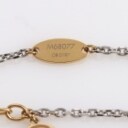 Louis Vuitton. Two-tone metal bracelet with logo pendant