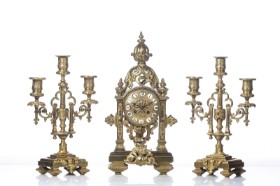 French Historicism mantel clock of gilded bronze with garnish, 19th century. (3)