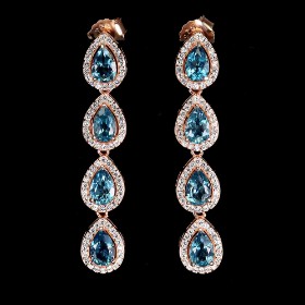 Earrings in 14 kt. red gold plated sterling silver with blue topazes..