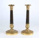 A pair of Empire style candlesticks, a silver candlestick, a glass candlestick (4)