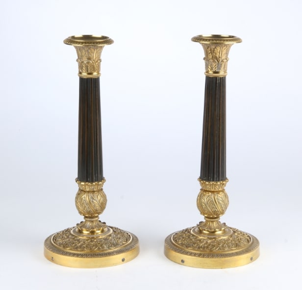 A pair of Empire style candlesticks, a silver candlestick, a glass candlestick (4)