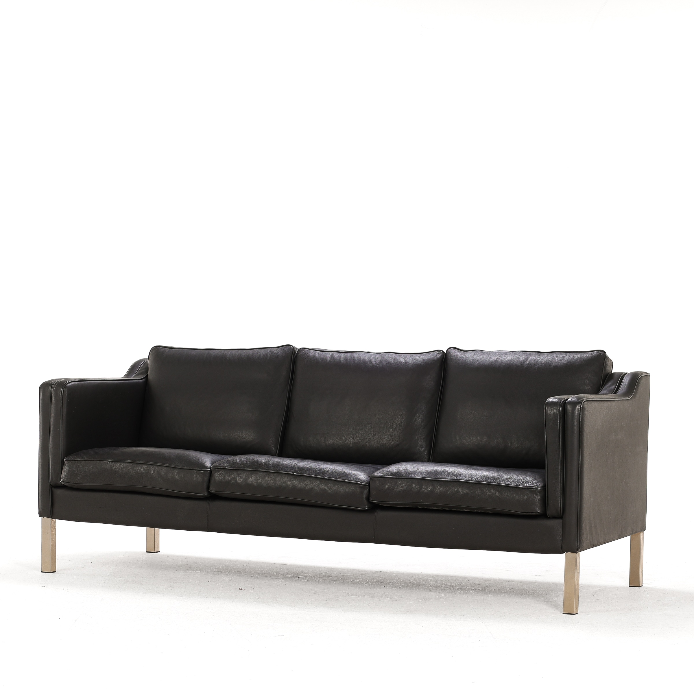 Three-seater sofa, black leather with steel legs