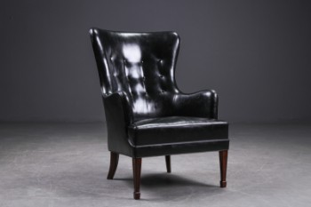 Fritz Henningsen. High-backed lounge chair, black leather, from the 1930s