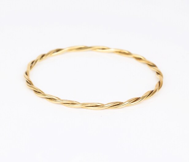 A twisted bangle of 14k gold. Weight 12.5 g.