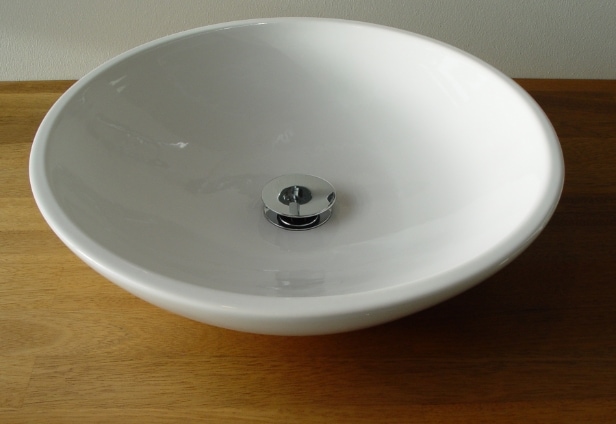 INVITA udstillingsbad. Badarrangement med porcelænsvask samt låger af hvid højtrykslaminat og mahogni 