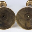 A pair of Empire style candlesticks, a silver candlestick, a glass candlestick (4)