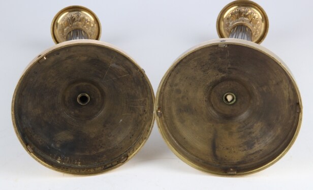 A pair of Empire style candlesticks, a silver candlestick, a glass candlestick (4)