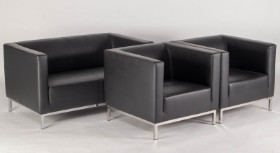 Two-person sofa and two armchairs upholstered in black leather