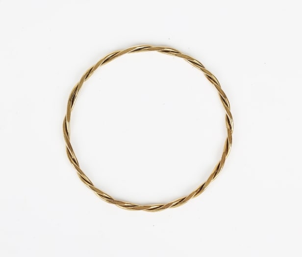 A twisted bangle of 14k gold. Weight 12.5 g.