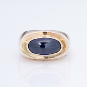 A. Ring: A ring of 14k gold with a synthetic sapphire. Circa 1970.