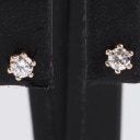 A pair of 14k gold solitaire earrings, 0.20 ct. (2)