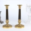 A pair of Empire style candlesticks, a silver candlestick, a glass candlestick (4)