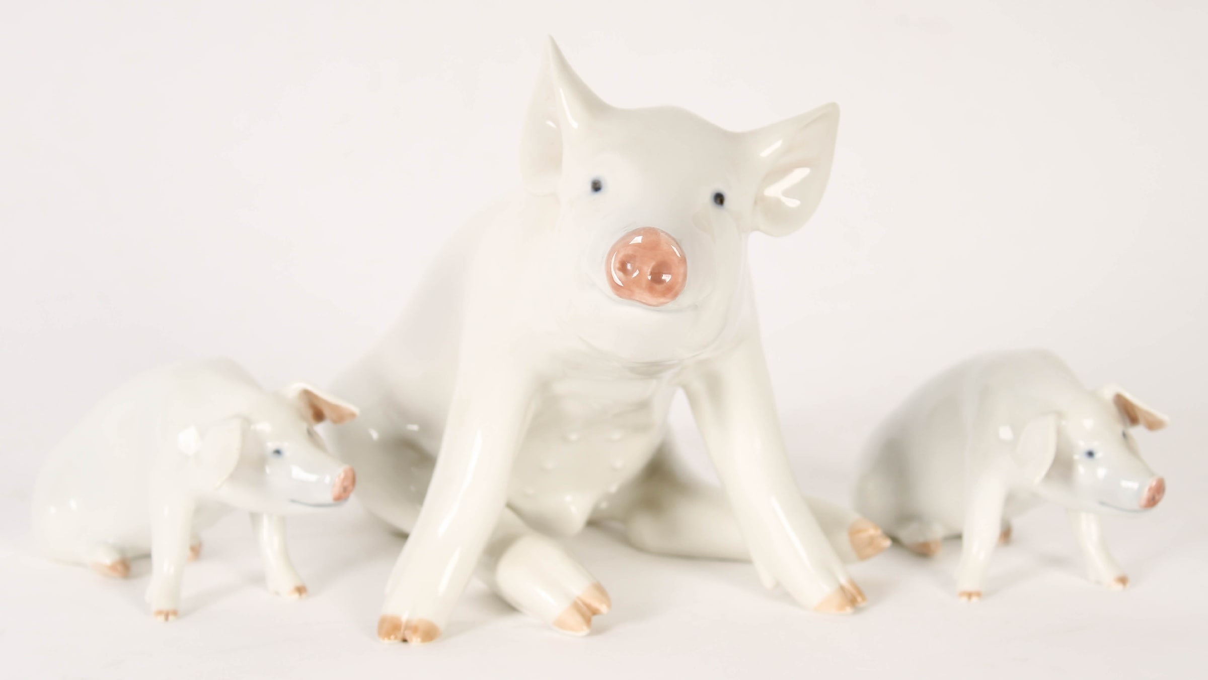Royal Copenhagen. Three sitting pigs. (3)