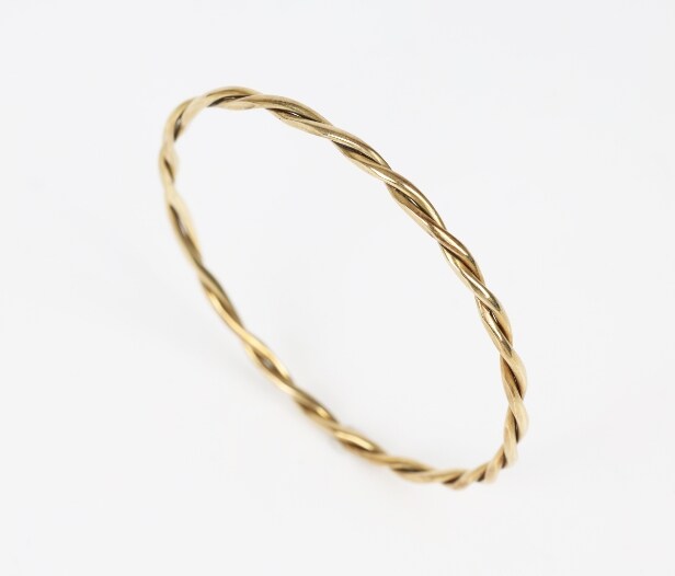 A twisted bangle of 14k gold. Weight 12.5 g.