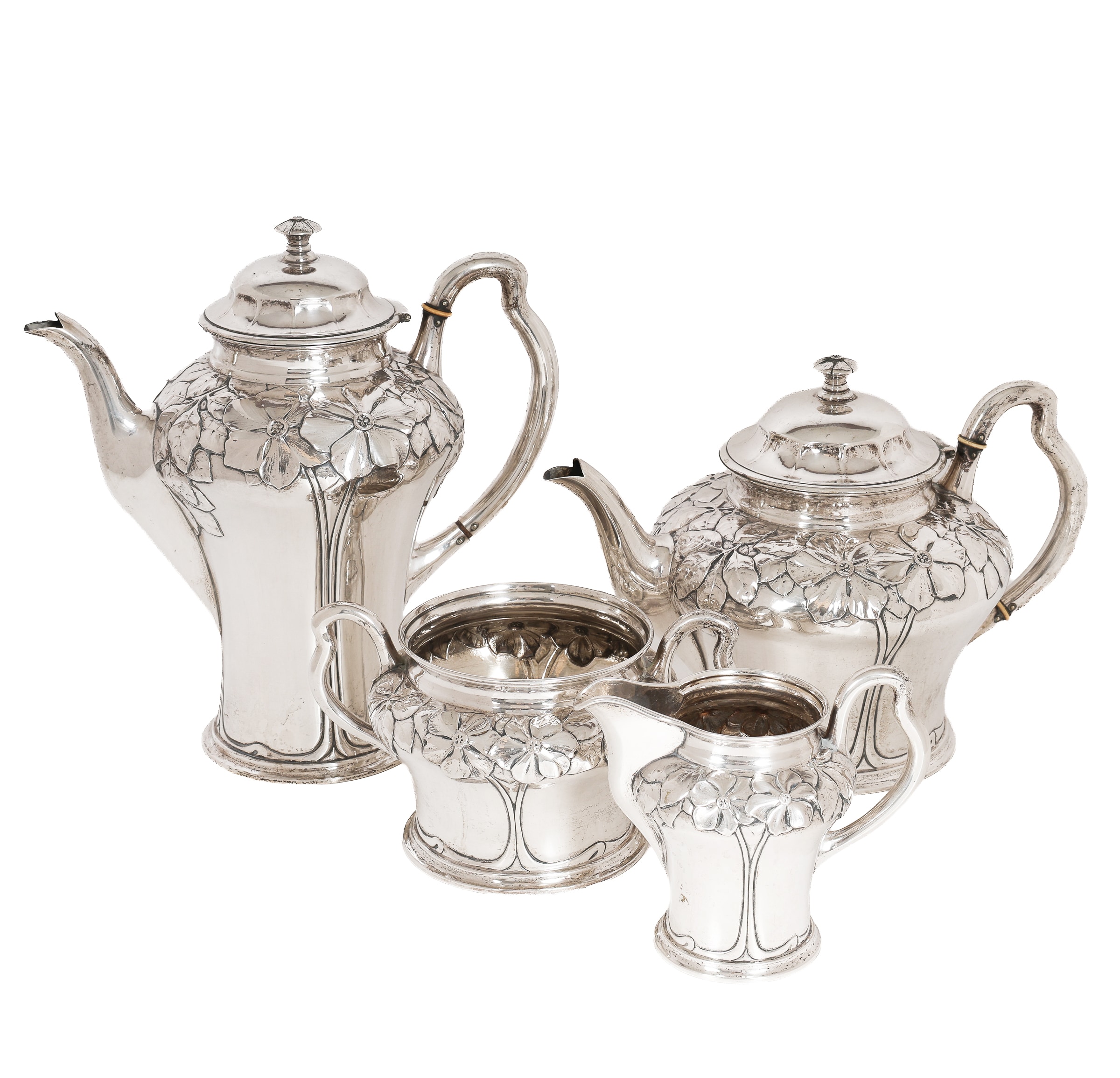 Danish fine art and Art Nouveau designed silver by a Danish silversmith: Set with teapot, coffee pot, sugar bowl and creamer of three-towered silver. (4)