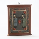 Small corner cabinet with carved figures on the door