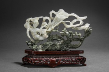 Chinese jade figure in the shape of a dragon and a floating person with a sword