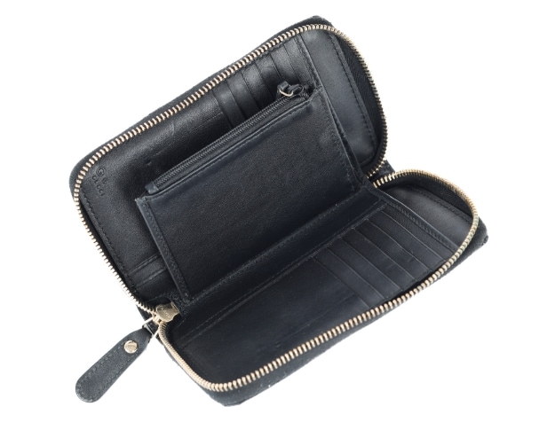 Gucci: A zipped wallet of black microguccissima embossed leather. Model 449423.